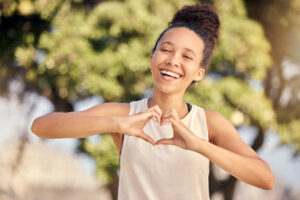 fitness black woman with heart hand sign love body care self care