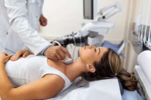 doctor-making-ultrasound-thyroid-gland-woman-patient-clinic-diagnosis-treatment-autoimmune-thyroiditis-concept (1)